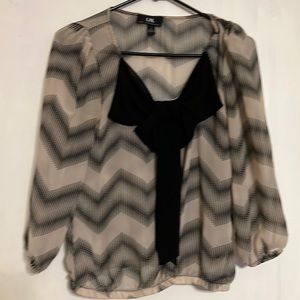 A Chevron print Black and Tan shirt with a bow!